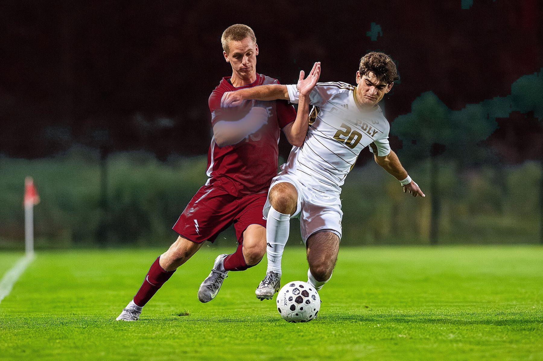 A Lions midfielder battles for the ball under the lights
