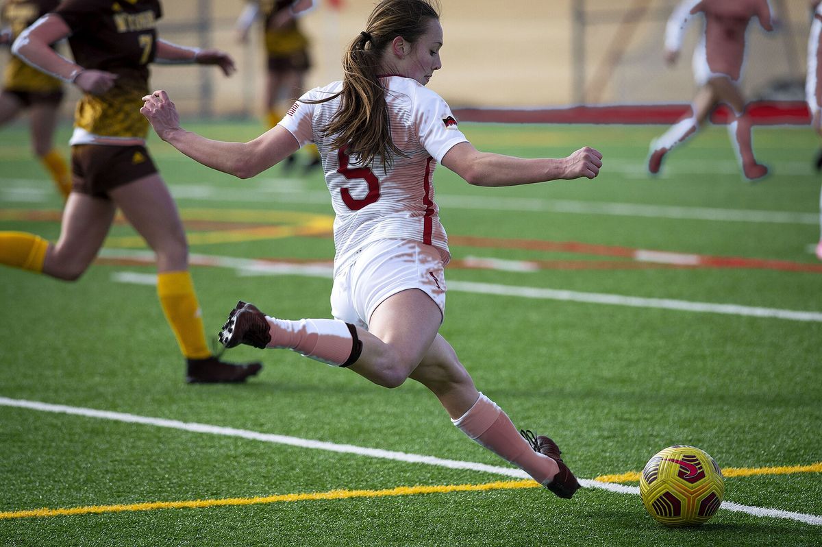 A Lions forward strikes the ball