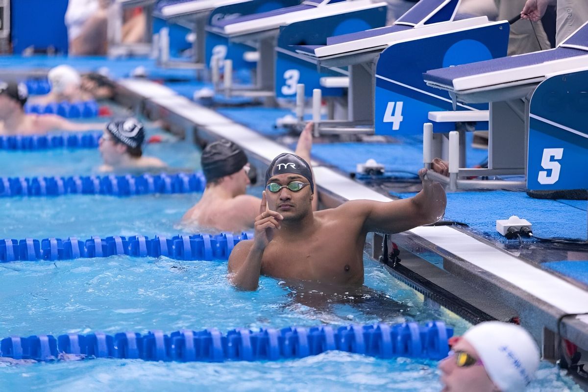 A swimmer celebrates at the wall