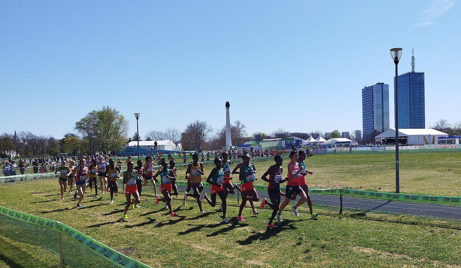A cross country field strings out across the course