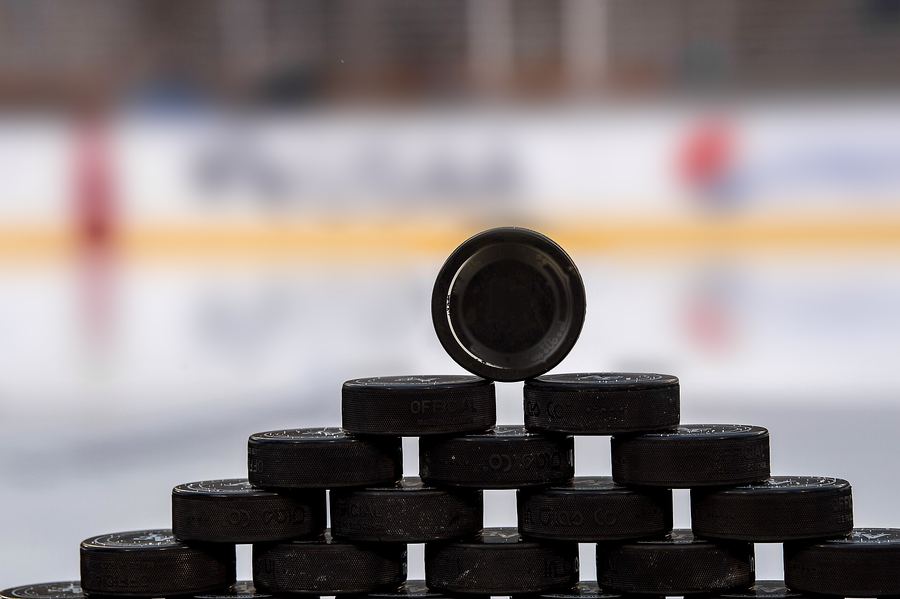 Practice pucks stacked on the ice