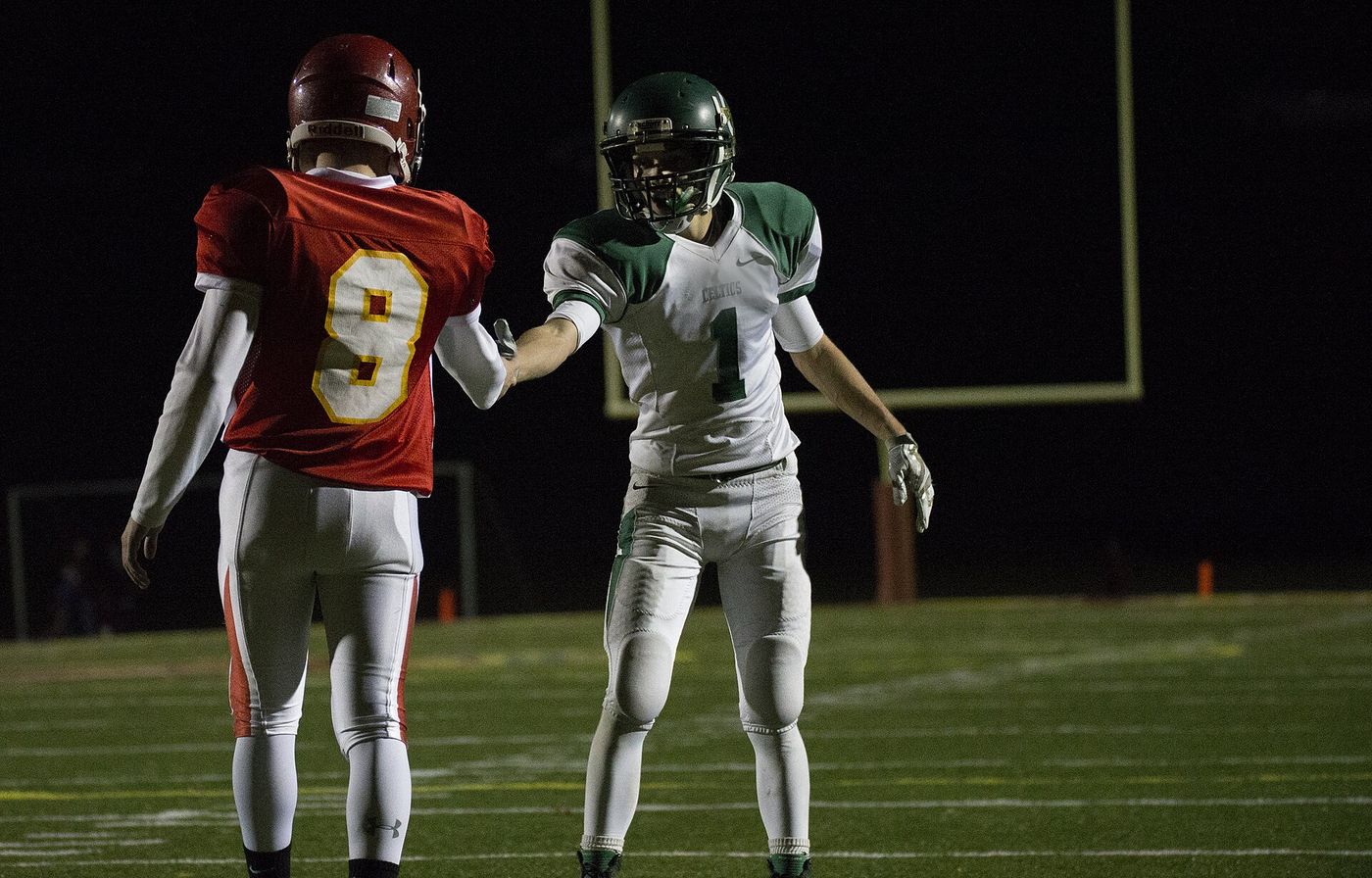 A Panthers receiver shakes hands with an opponent before the snap